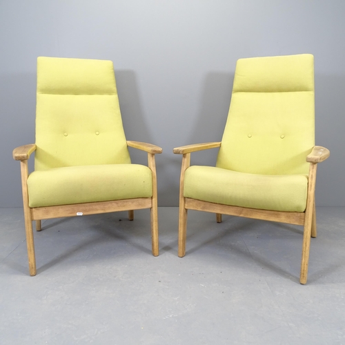 2538 - A pair of mid-century teak and upholstered lounge chairs, in the Danish manner.