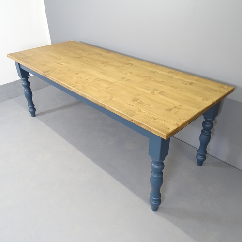 2556 - A modern painted pine dining table, on turned legs. 210x77x84cm.