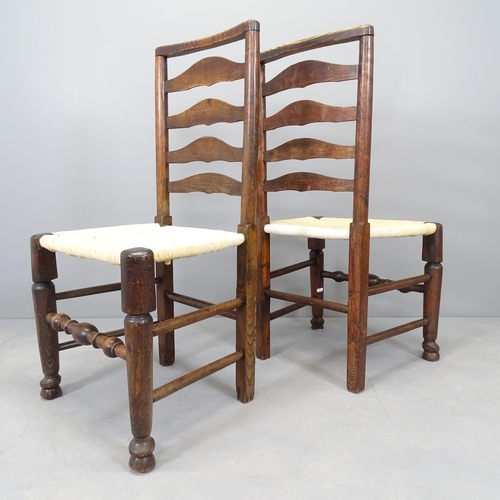 2559 - A matched set of seven oak and elm rush seated ladder back dining chairs.