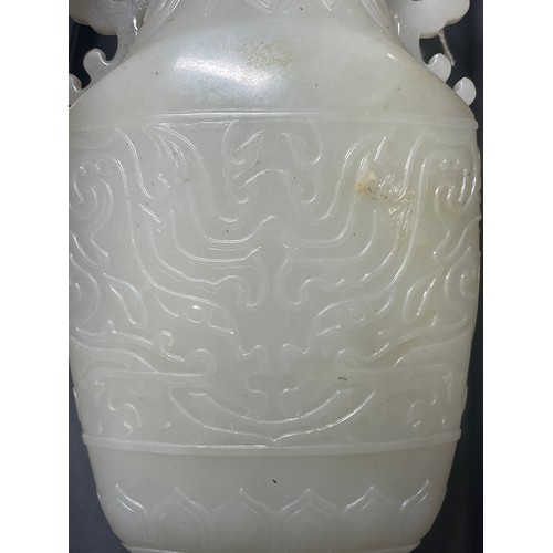 144 - A large Chinese relief carved jade 2-handled vase and cover, on dark green jade pedestal, overall he... 
