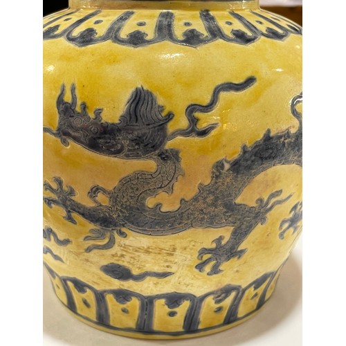 143 - A Chinese yellow ground porcelain jar and cover, with blue painted dragon designs, 6 character mark,... 