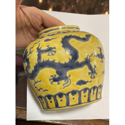 143 - A Chinese yellow ground porcelain jar and cover, with blue painted dragon designs, 6 character mark,... 