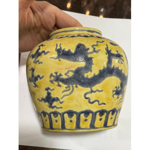 143 - A Chinese yellow ground porcelain jar and cover, with blue painted dragon designs, 6 character mark,... 