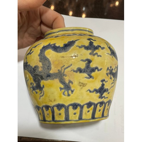 143 - A Chinese yellow ground porcelain jar and cover, with blue painted dragon designs, 6 character mark,... 