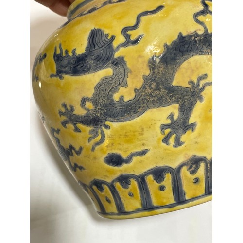 143 - A Chinese yellow ground porcelain jar and cover, with blue painted dragon designs, 6 character mark,... 