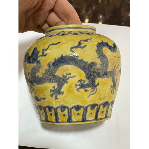 143 - A Chinese yellow ground porcelain jar and cover, with blue painted dragon designs, 6 character mark,... 