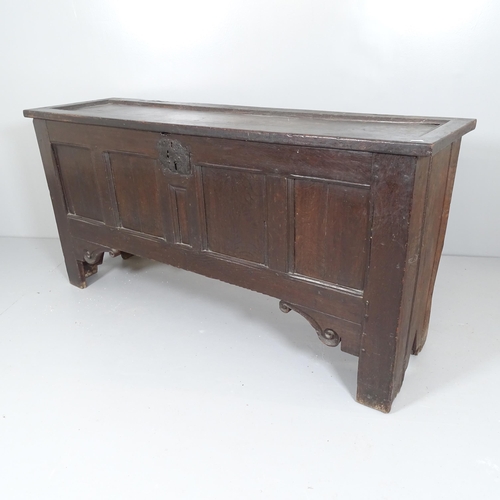 2585 - An antique panelled oak coffer, raised on style legs. 145x74x43cm