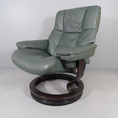 2562 - An Ekornes green leather upholstered swivel lounge chair.