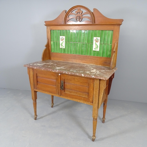 2563 - A Victorian mahogany marble-topped wash stand, with raised tiled back, cupboards under, raised on tu... 