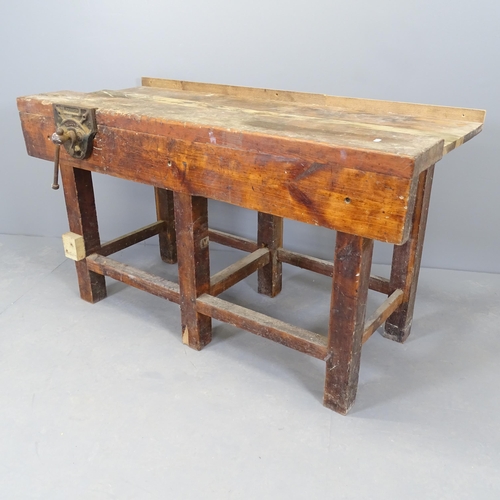 2569 - A vintage stained pine work bench, with Record vice. 135x77x69cm