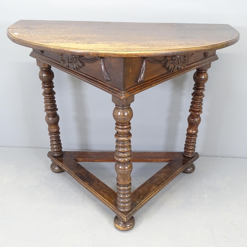 2571 - An early 20th century mahogany demi-lune console table, with applied carved swag decoration and rais... 