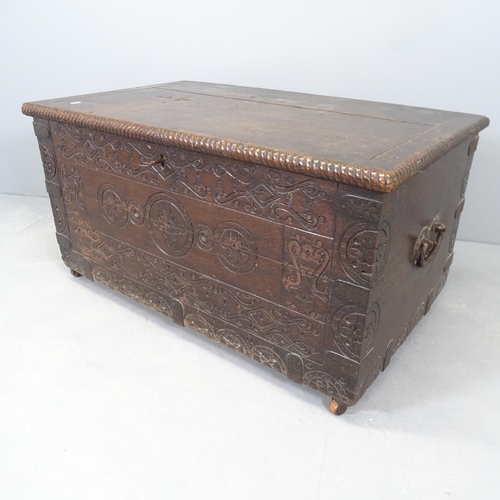 2587 - An antique carved oak blanket box, mounted on casters. 102x54x65cm.