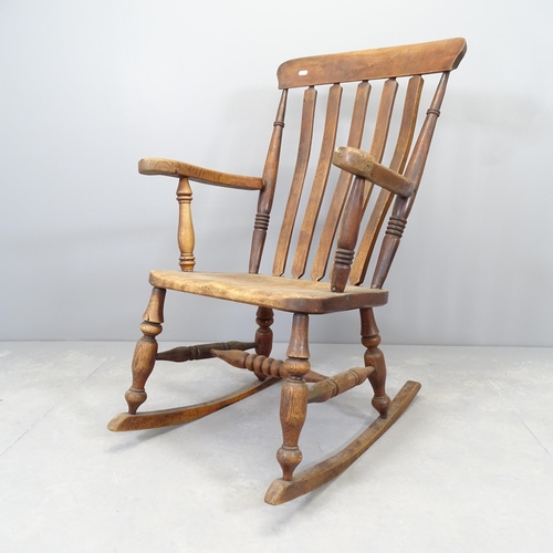 2590 - An antique elm-seated rocking chair.