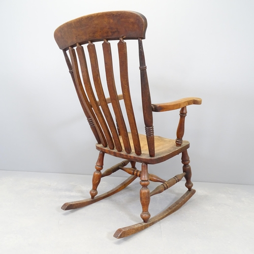 2590 - An antique elm-seated rocking chair.