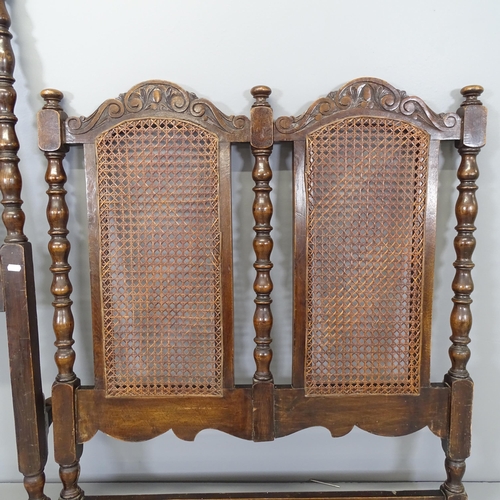 2599 - An antique oak framed single bed, with cane panelled head and footboards, with side rails.