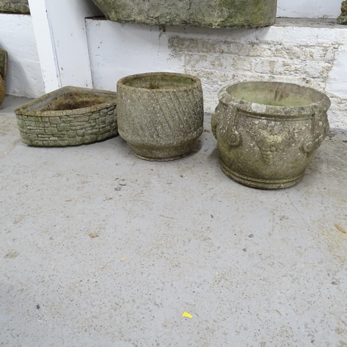 2634 - Two weathered circular concrete planters, 40x32cm, and another corner concrete planter.