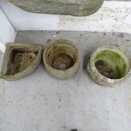 2634 - Two weathered circular concrete planters, 40x32cm, and another corner concrete planter.