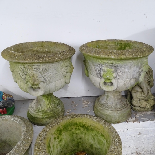 2636 - A pair of two-section weathered concrete garden planters with lion mask decoration. 55x66cm