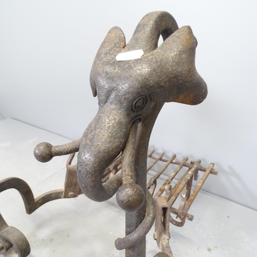 2638 - A pair of wrought Iron fire dogs, one topped with a crystal ball and the other with an elephant head... 