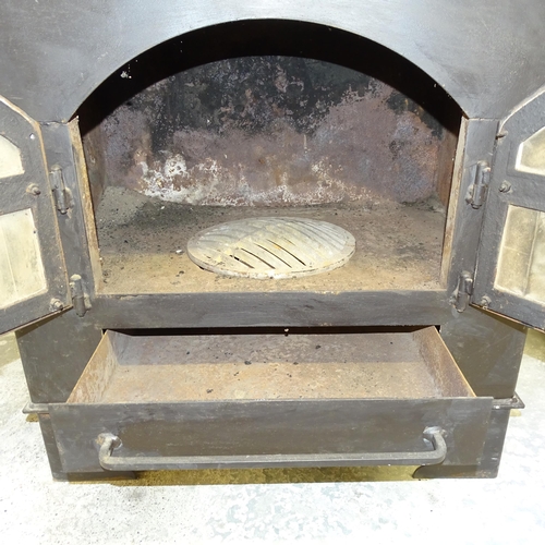 2644 - A cast iron wood burning stove. 78x140x65cm