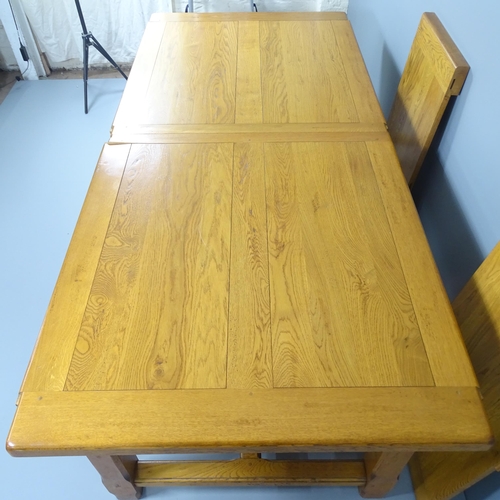 2053 - A modern light oak draw-leaf dining table. 220 (extending to 310)x78x102cm.