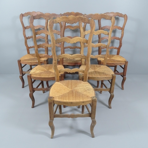 2054 - A set of six French oak ladderback dining chairs.