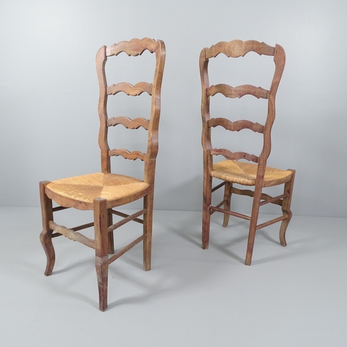 2054 - A set of six French oak ladderback dining chairs.