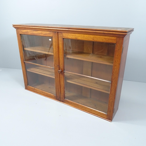 2059 - An antique mahogany bookcase, with two glazed doors and two fixed shelves. 127x84x28cm