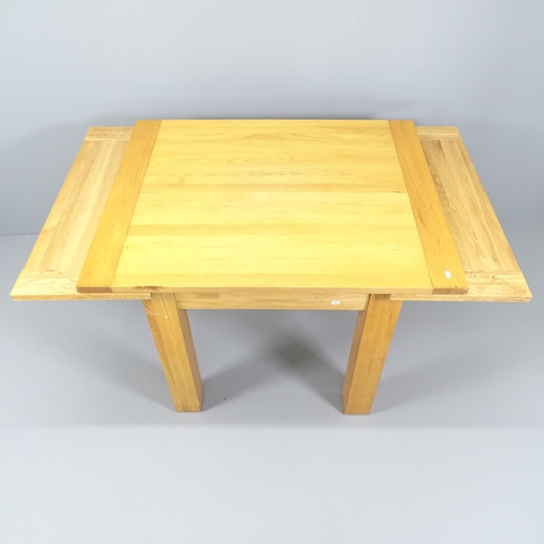 2061 - A modern light oak draw-leaf dining table. 110 (extending to 190) x79x90cm.