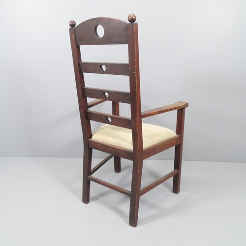 2071 - An Arts & Crafts oak ladder back armchair with heart and circle cut-outs.