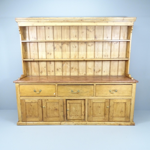 2075 - A 19th century Pine two section dresser, with open plate rack, three frieze drawers and cupboards un... 