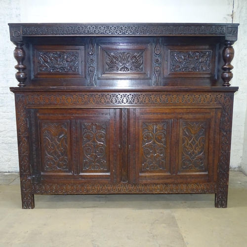 2076 - An antique carved oak court cupboard. 182x153x53cm