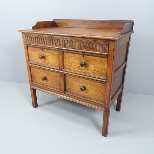 2079 - An early 20th century oak sideboard, with raised top, carved secret drawer, and two short and one lo... 