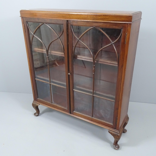 2084 - A antique mahogany bookcase, with two glazed doors, two adjustable shelves and raised on cabriole le... 