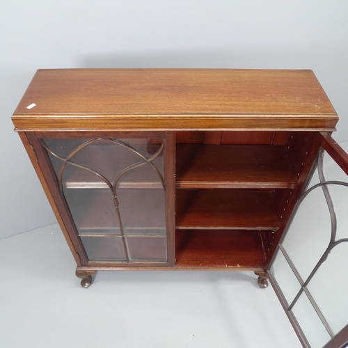 2084 - A antique mahogany bookcase, with two glazed doors, two adjustable shelves and raised on cabriole le... 