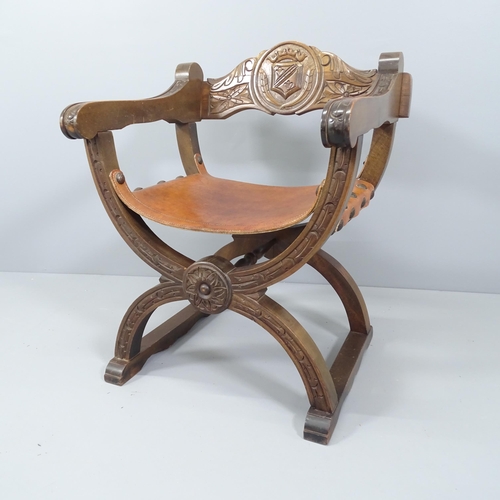 2091 - A modern carved oak Savonarola chair, with leather seat.