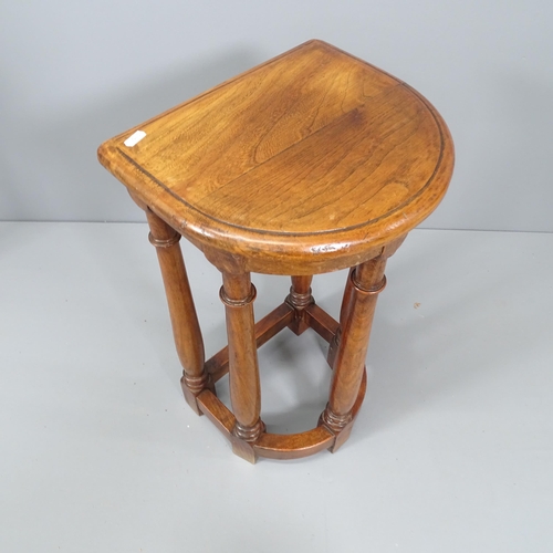 2093 - An antique oak demilune jardiniere stand. 36x63x30cm.