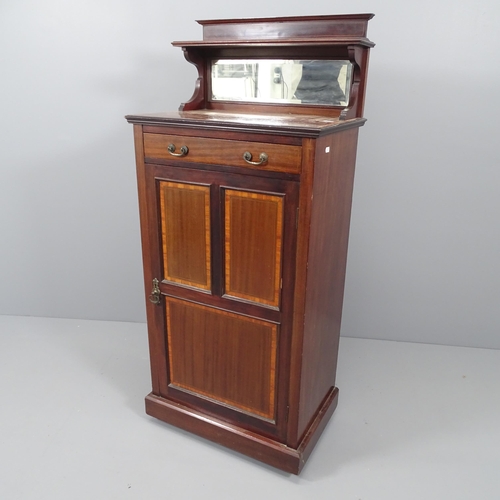 2100 - An Edwardian mahogany and satinwood strung music cabinet, with raised mirrored back and single panel... 