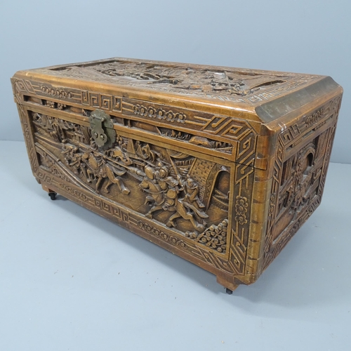 2108 - A Chinese camphorwood blanket box, with all-over carved decoration. 89x48x44cm.