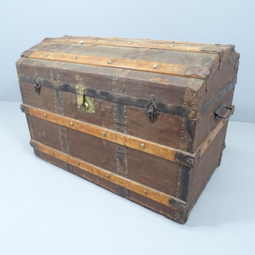 2120 - A Victorian dome top trunk, with tray fitted interior and various travel labels to the interior incl... 