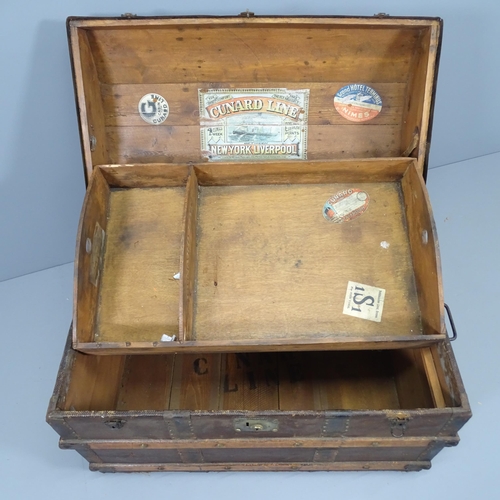 2120 - A Victorian dome top trunk, with tray fitted interior and various travel labels to the interior incl... 