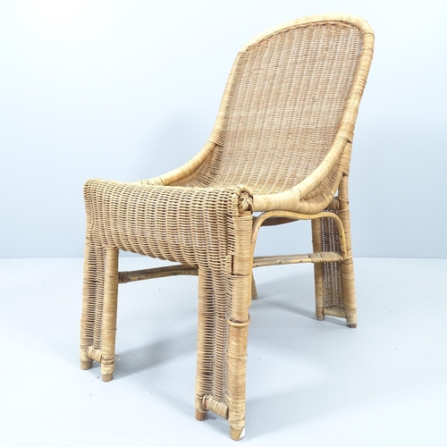 2138 - A mid-century French wicker chair in the manner of Louis Sognot.