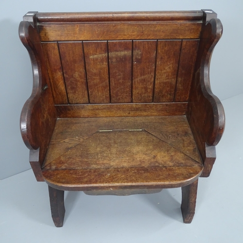 2141 - An antique oak church misericord, the seat rising to reveal a carved panel and rest. Dimensions over... 