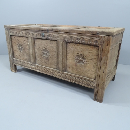 2145 - An antique panelled oak coffer, with carved English rose decoration and raised on stile legs. 131x61... 