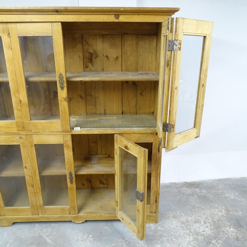 2653 - An antique pine bookcase, with four glazed panelled bi-fold doors and four fixed shelves. 140x160x43... 