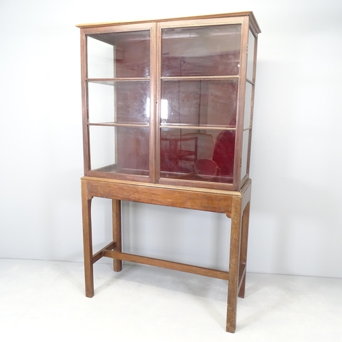 2655 - An antique mahogany two-section shop display cabinet on stand, with two fixed shelves. 103x175x43cm.