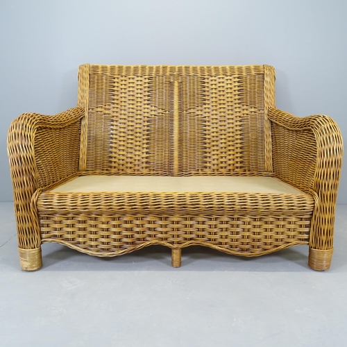 2657 - A modern wicker three-piece conservatory suite, comprising a two-seater sofa, 134x95x100cm, and two ... 