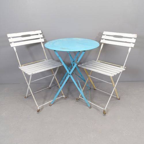 2660 - A painted metal folding bistro table, 60x70cm, and two folding chairs.