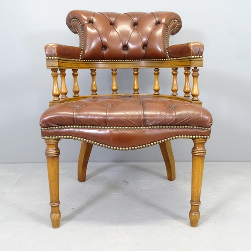 2669 - An early 20th century mahogany and leather upholstered bow arm chair.