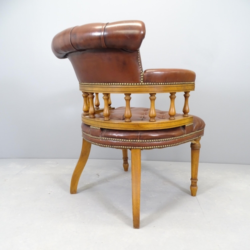 2669 - An early 20th century mahogany and leather upholstered bow arm chair.